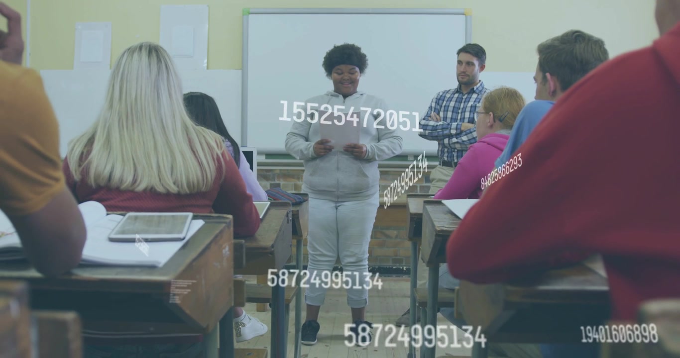 Vertical video: Reading student in gray hoodie presenting paper to classmates with numeric overlays