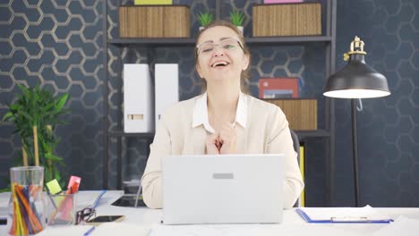 Loving-business-woman-making-heart-symbol-at-camera.