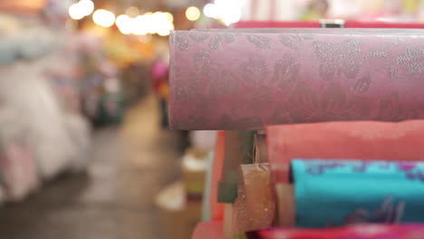 assorted colorful wrapping paper and fabric rolls