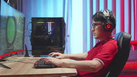 asian gamer man playing survival shooter games
