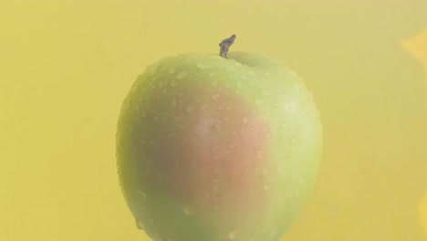 Ripe green apple Isolated on yellow background. Concept of healthy food and diet. Vegetarian food. 4k video