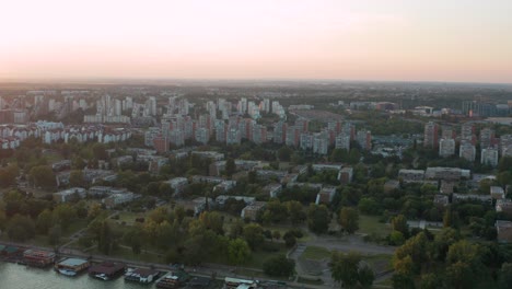 aerial view of residential buildings near the river in the outskirts of belgrade during the sunset