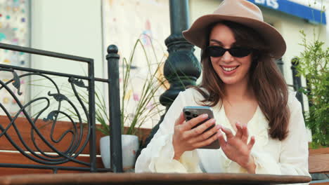 woman using phone in a cafe