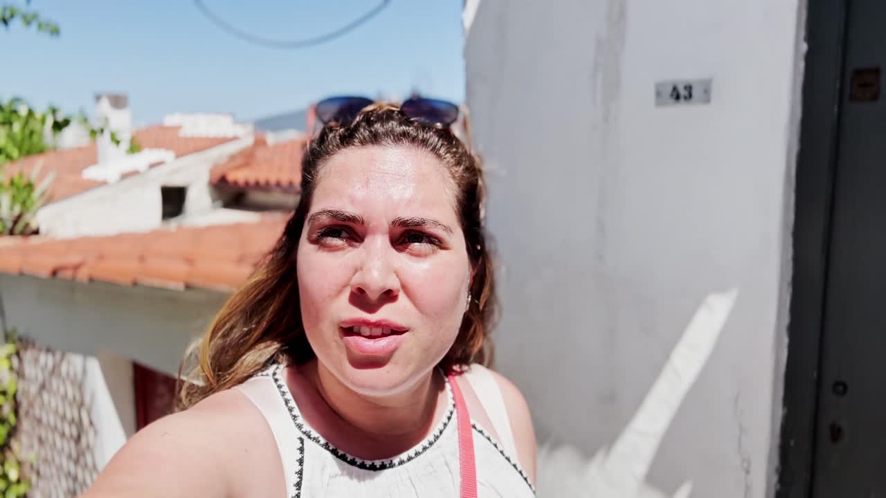 Vlogger Woman Taking a Selfie in a Narrow Alley