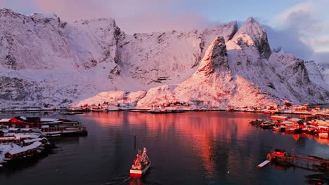 breathtaking sunrise over a snow-covered village in the lofoten islands