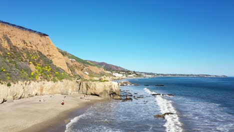 Drone-shot-of-El-Matador-Beach-in-Malibu-California-showing-the-ocean,-white-water-waves-and-beach-from-above