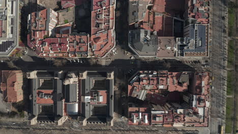 Birds-eye-shot-of-buildings-in-city.-Blocks-of-various-houses-in-urban-borough-from-height.-Barcelona,-Spain