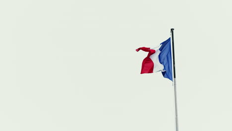 slow motion footage of the french flag flying in the wind