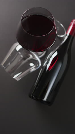 vertical video of red wine glasses on wooden surface