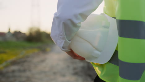 close-up of a construction worker holding a hard hat