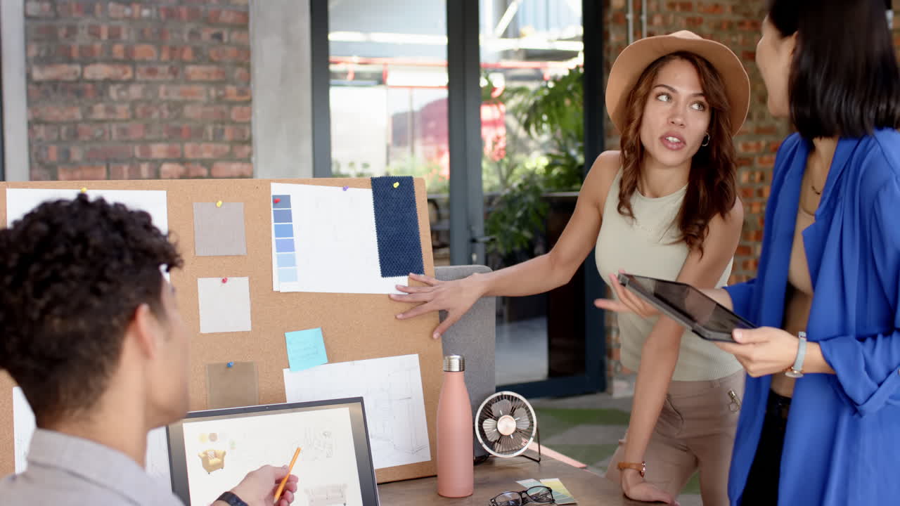 Interior design, multiracial team collaborating with mood board and digital tablet, at office