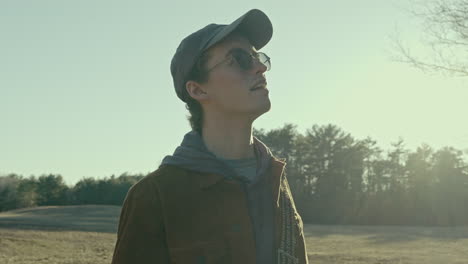 young photographer observes the forest and takes a photograph