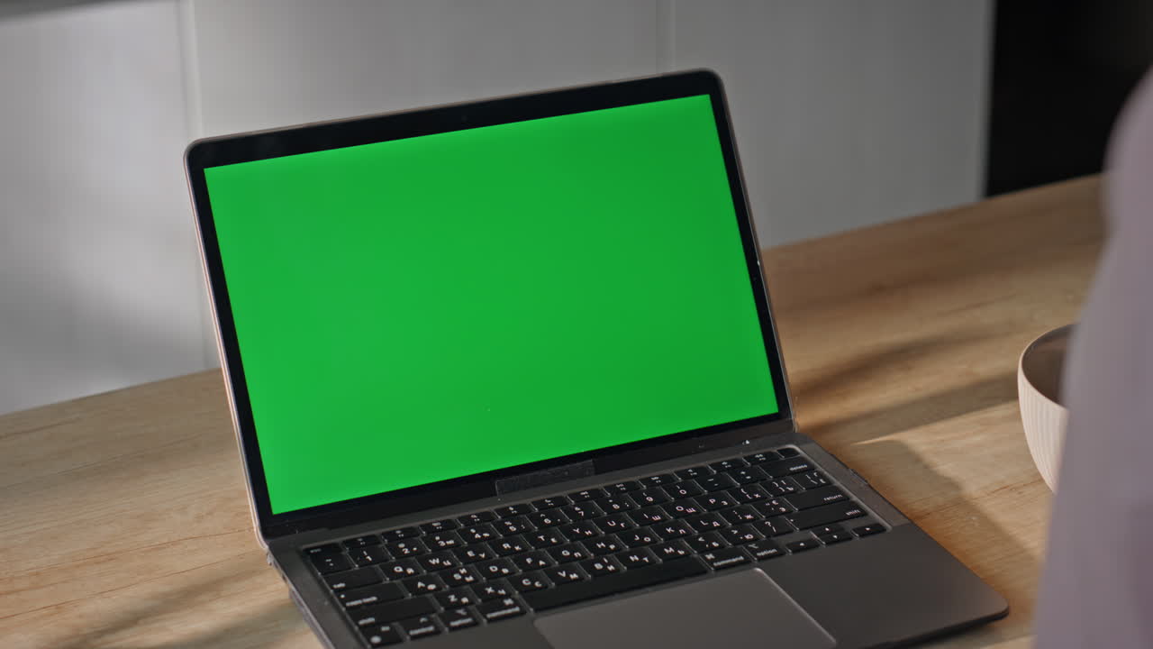 Remote employee looking mockup laptop having video conference at home close up.