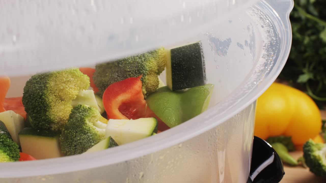 Mixed vegetables, carrots, broccoli, and cauliflower in a food double boiler steamer basket in a stainless steel pot, healthy diet cooking method preserving minerals, vitamins and flavor