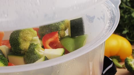 mixed vegetables, carrots, broccoli, and cauliflower in a food double boiler steamer basket in a stainless steel pot, healthy diet cooking method preserving minerals, vitamins and flavor