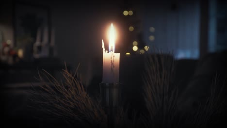 a single lit candle in a cozy warm environment at christmas time