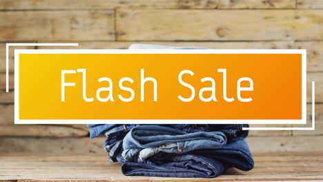 animación de texto de venta flash sobre pantalones de denim sobre fondo de madera
