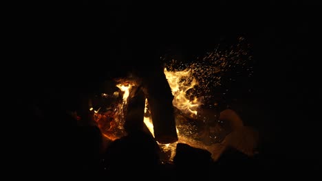 fire and sparks rise over burning woods - campfire outdoor - static shot