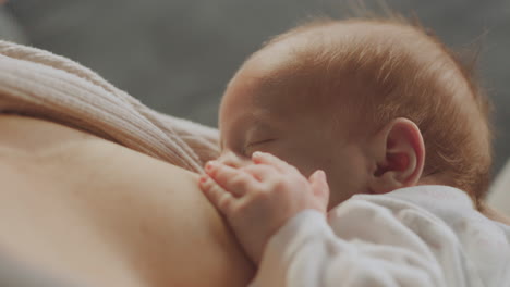mother breastfeeding newborn baby