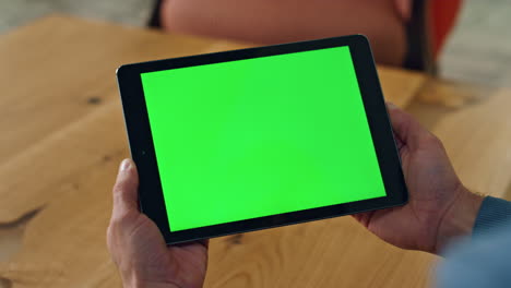 user holding chromakey computer indoors closeup. man reading template device