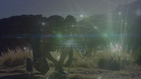 animación de la red de conexiones brillantes sobre afroamericano hombre en forma atando cordones de zapatos al aire libre