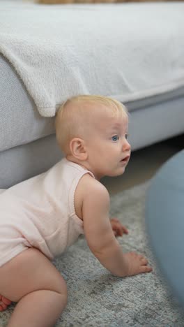 baby crawling near sofa