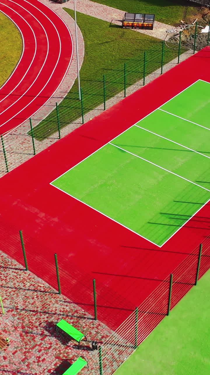 Modern sports grounds. Flight over colorful stadiums with nobody ...