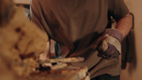 worker prepares for welding by putting on protective gloves