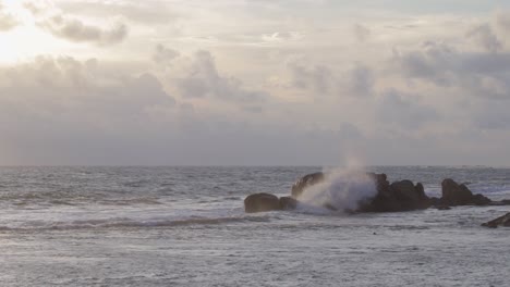 sea waves crashing on to rocks in distance, evening galle fort seashore slow mo b roll clip