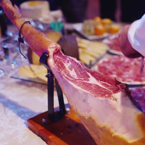 man cuts jamon into thin slices 1