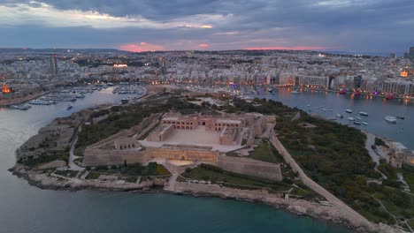 An-aerial-view-of-Maneol-Island-in-Marsamxett-Harbour,-Malta