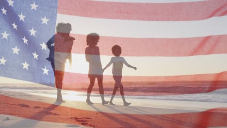 happy african american parents with son and daughter walking on beach by sea