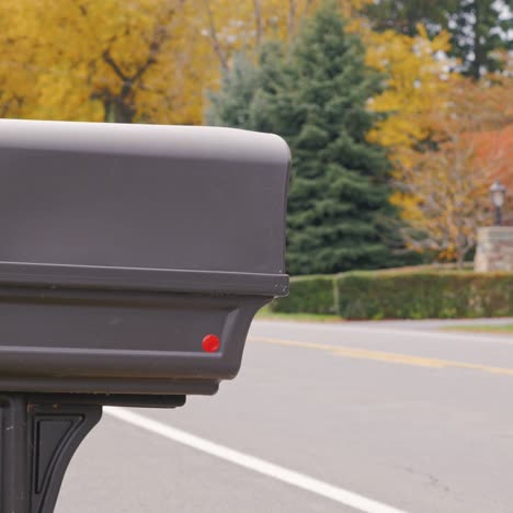 Us-Mail-Delivery-Where-A-Man-Picks-Up-Mail-From-The-Mailbox-Beside-The-Road