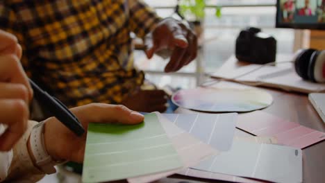 Graphic designers working together at desk in a modern office 4k