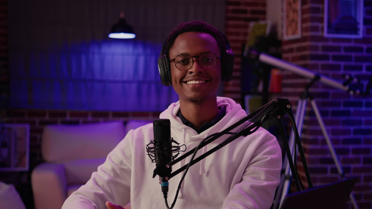 Portrait of man content creator smiling confident at camera while answering questions from listeners