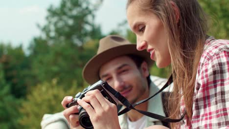 Woman-taking-a-photo-during-hiking-trip