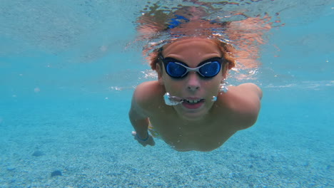 slow motion - teenager swims underwater