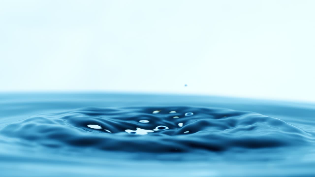 Drop of water falls into a drop of water in a super slow motion. Shot on super slow motion 1600 fps