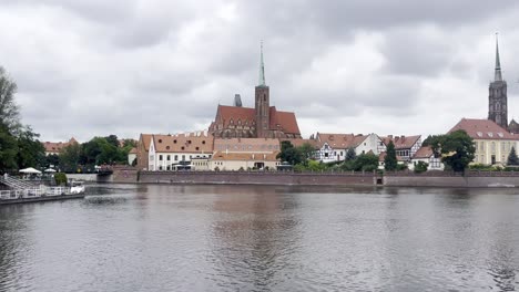 overlooking cathedral island from other side of river odra on a moody and grey morning in wrocław, poland