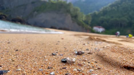 low angle view of incredible sandy beach landscape, sea rises and tide comes in, focus in foreground