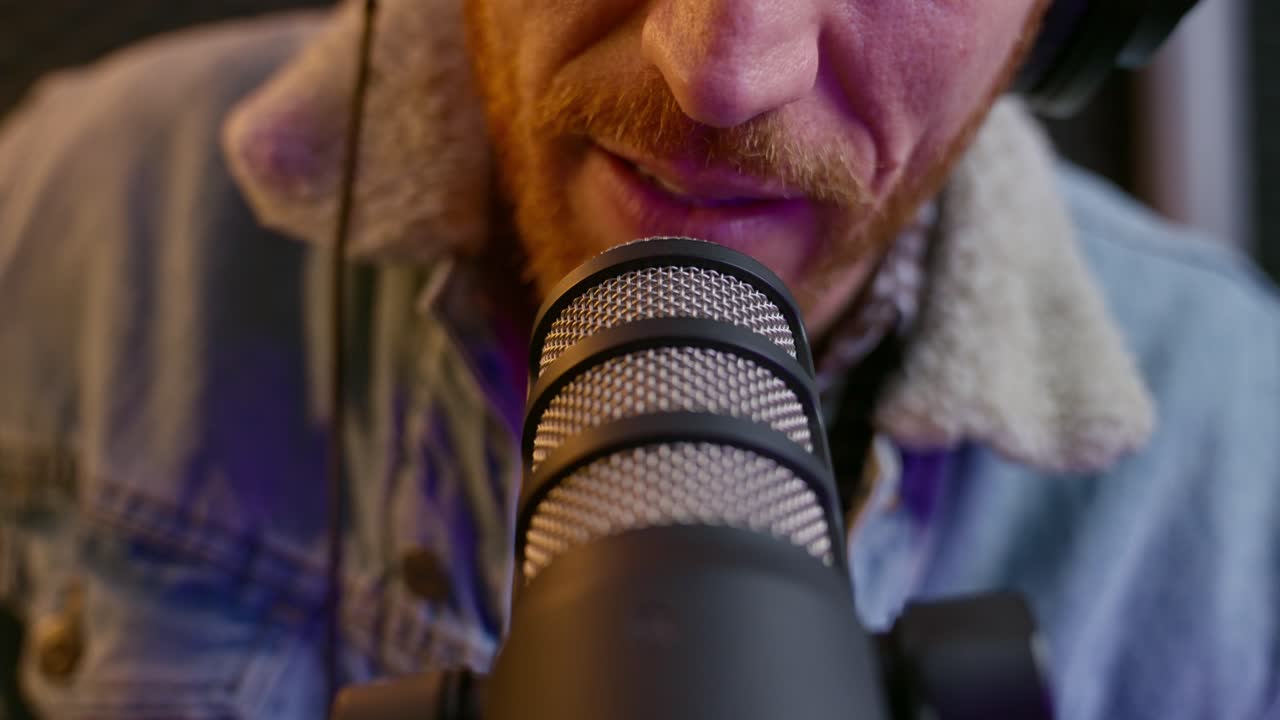 Podcaster close up. mouth of influencer speaking into a microphone. Captures precise lip movements, rich dynamics, and the focus of professional podcasting. guy putting on head phones broadcasting