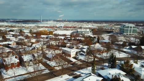 winter aerial view over snow covered homes and buildings in oakville, ontario