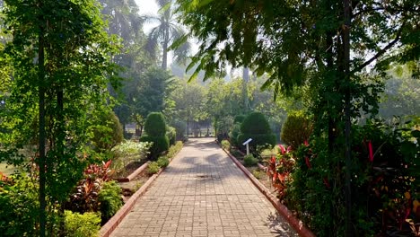 Paved-path-leads-to-relaxed-peaceful-Kamati-Baugh-botanical-parkland-India