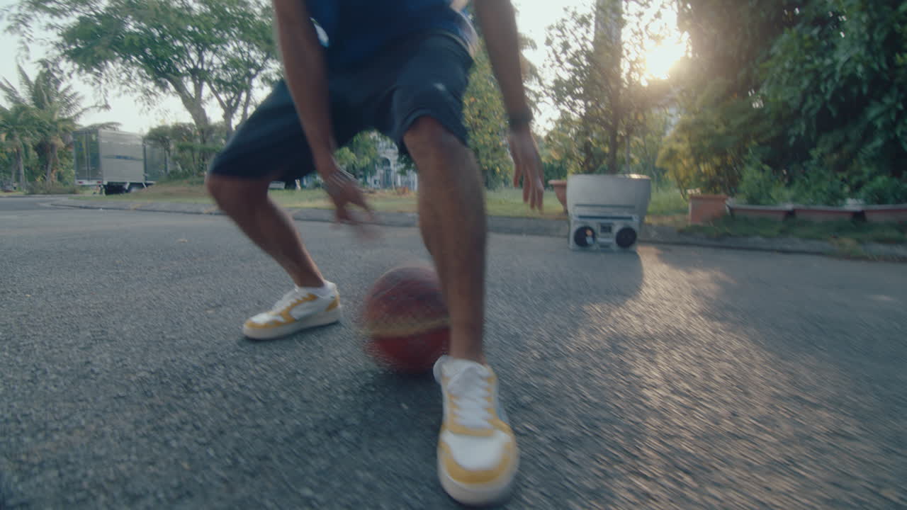 Young Basketballer Dribbling Ball on Camera at Outdoor Playground