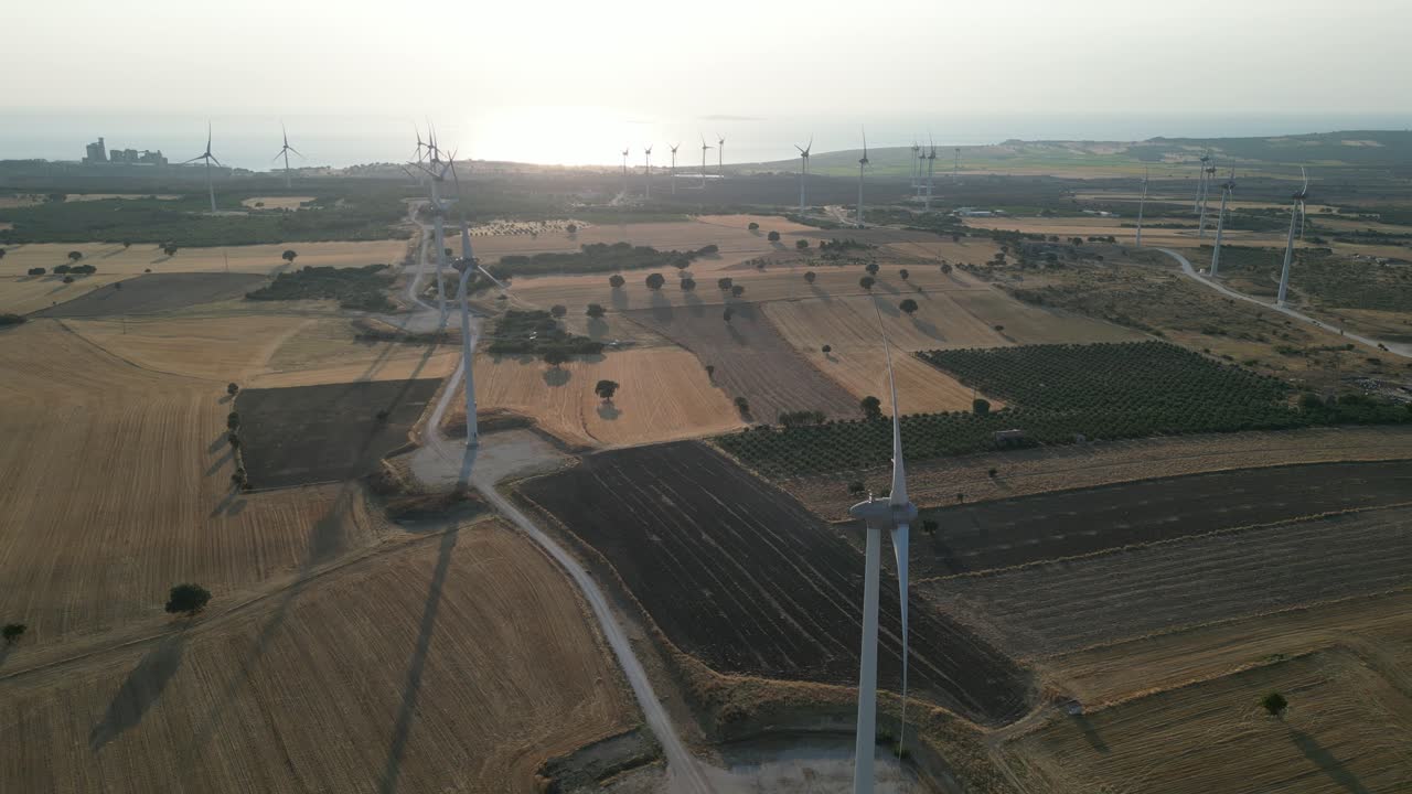 Aerial video of windmills at sunset