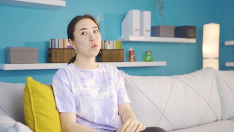 happy and peaceful asian young woman whistling at home.