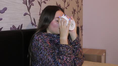 teenage girl freezing while sitting in her room with a cup of tea, autumn