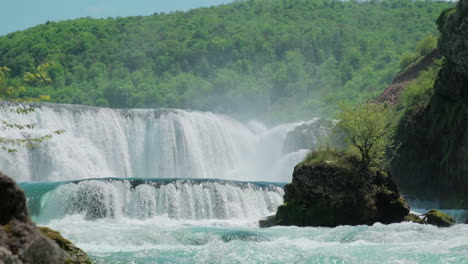 a waterfall of a pure wild river located in a green rainforest