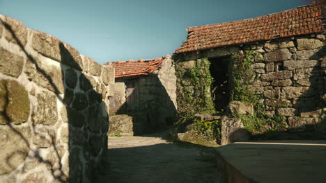 traditional street with abandoned stone houses in a portuguese countryside village