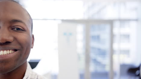 Half-portrait-of-happy-african-american-man-in-hospital-with-copy-space,-slow-motion